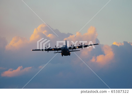 C-130 Hercules flying in the dusk C-130 Hercules flying in the dusk 65387322