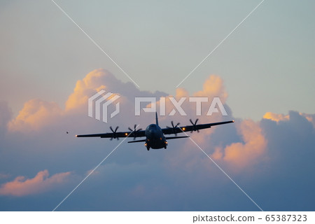 C-130 Hercules flying in the dusk C-130 Hercules flying in the dusk 65387323