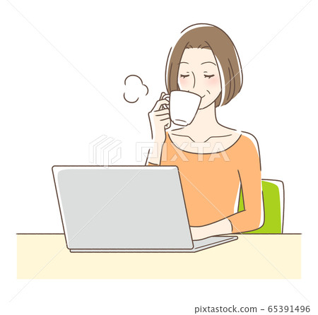 A woman drinking coffee in front of a computer A woman drinking coffee in front of a computer 65391496