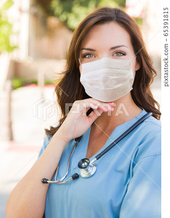 Female Doctor or Nurse Wearing Protective Face Mask Female Doctor or Nurse Wearing Protective Face Mask 65391815