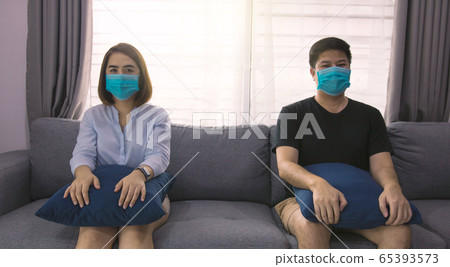 Two asian couple lovers sit on the sofa at home 65393573