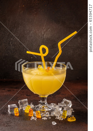 Delicious cold refreshing ananas smoothie drink in cocktail glass Delicious cold refreshing ananas smoothie drink in cocktail glass 65394717