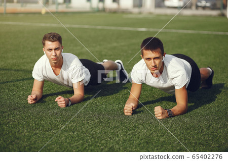 Handsome man training in a summer park Handsome man training in a summer park 65402276