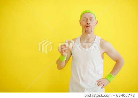 bald funny man with a donut on a yellow background. funny fitness. retro style bald funny man with a donut on a yellow background. funny fitness. retro style 65403778