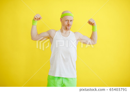 funny bald man in a sports uniform on a yellow background. retro style funny bald man in a sports uniform on a yellow background. retro style 65403791