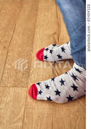 Funny socks. Legs of a young man in funny socks 65404328