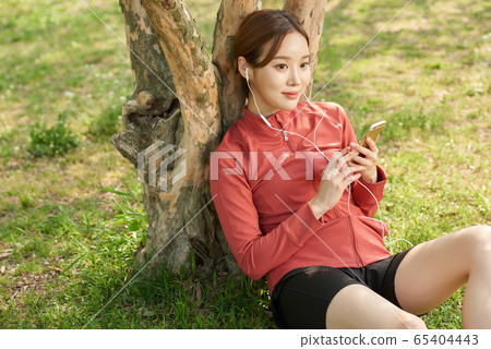 Pretty 20s woman exercising in the park Pretty 20s woman exercising in the park 65404443