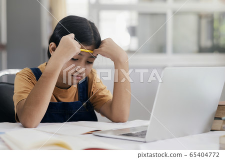 Happy asian girl learning online at home 65404772