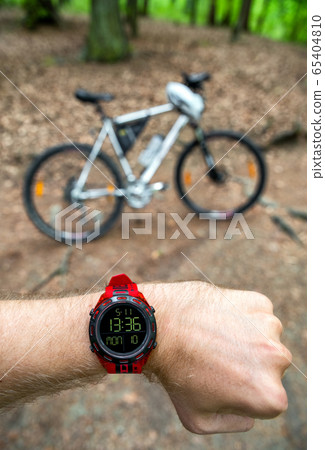 Biker looking on wearable sports watch and 65404810