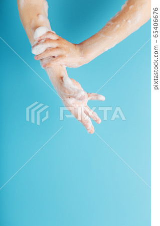 Hands of a child in soapy antibacterial foam, on a Hands of a child in soapy antibacterial foam, on a 65406676