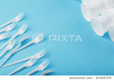 Dishes made of white plastic on a blue background. 65406704