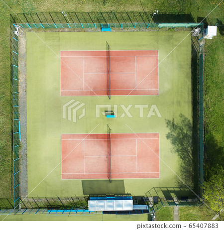 Two empty tennis courts 65407883