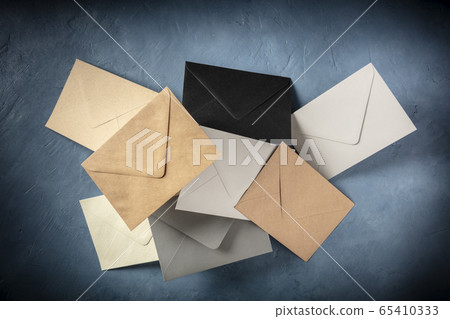 C6 envelopes, brown, gray, and black, flying in the air C6 envelopes, brown, gray, and black, flying in the air 65410333