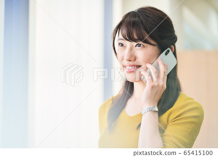 A woman making a phone call A woman making a phone call 65415100