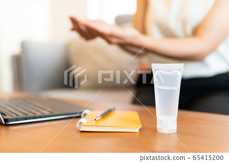 Young Asian woman cleansing hand by sanitizer gel Young Asian woman cleansing hand by sanitizer gel 65415200