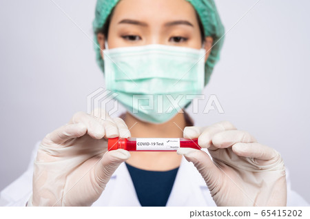 Young Asian doctor holding blood sample test tube on white background Young Asian doctor holding blood sample test tube on white background 65415202