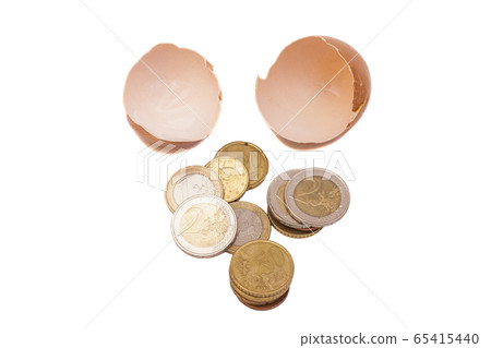 Broken egg with euro coins 65415440