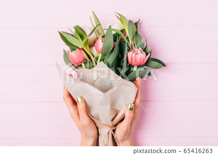 Top view of female hands holding lush bouquet of Top view of female hands holding lush bouquet of 65416263