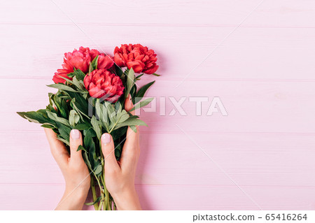 Female hands with manicure hold bouquet of fresh Female hands with manicure hold bouquet of fresh 65416264