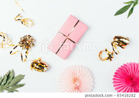 Flat lay composition of pink gift box next to 65416282