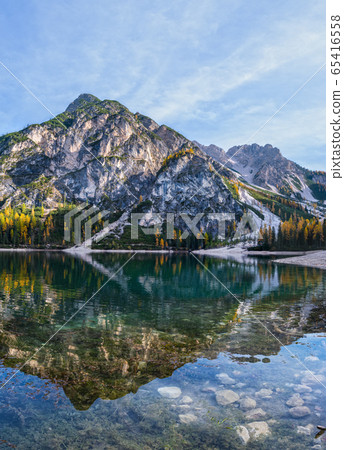 Autumn peaceful alpine lake Braies or Pragser 65416558