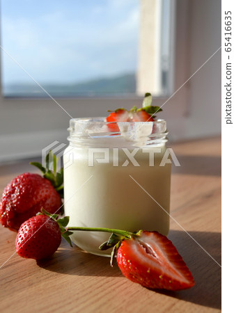 Yogurt with strawberries on a wooden table. Tasty Yogurt with strawberries on a wooden table. Tasty 65416635