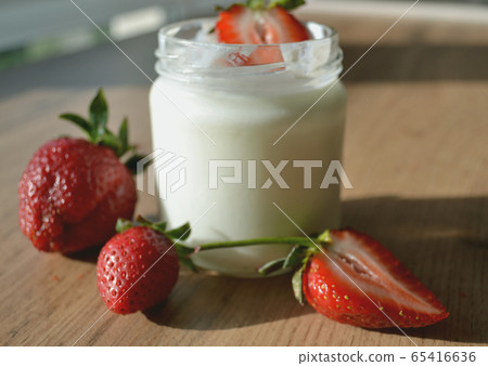 Yogurt with strawberries on a wooden table. Tasty Yogurt with strawberries on a wooden table. Tasty 65416636