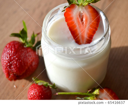 Yogurt with strawberries on a wooden table. Tasty Yogurt with strawberries on a wooden table. Tasty 65416637