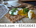 Poached egg on a whole grain bread with arugula  65416643