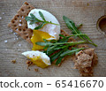 Poached egg on a whole grain bread with arugula on 65416670