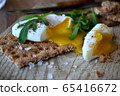 Poached egg on a whole grain bread with arugula on 65416672