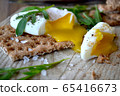 Poached egg on a whole grain bread with arugula on 65416673