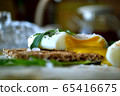 Poached egg on a whole grain bread with arugula on 65416675