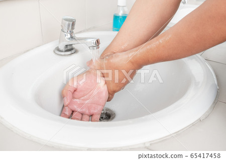 Men's hands wash their hands with soap clean hands in the tub with soap, personal hygiene 65417458