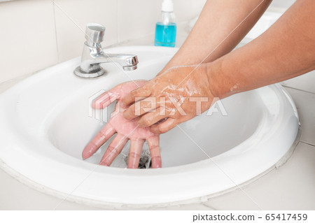 Men's hands wash their hands with soap clean hands in the tub with soap, personal hygiene 65417459