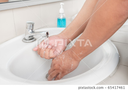 Men's hands wash their hands with soap clean hands in the tub with soap, personal hygiene 65417461