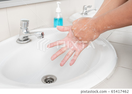 Men's hands wash their hands with soap clean hands in the tub with soap, personal hygiene 65417462