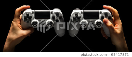 Set of hands holding video game gamepad in neon lights isolated on a black Set of hands holding video game gamepad in neon lights isolated on a black 65417871