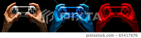 Set of hands holding video game gamepad in neon lights isolated on a black Set of hands holding video game gamepad in neon lights isolated on a black 65417876