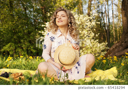 Beautiful woman, weekend out for a walk in a picnic park in the summer garden Beautiful woman, weekend out for a walk in a picnic park in the summer garden 65418294