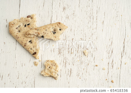 leftover crumbs of biscuits on a wooden table 65418336