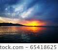 Colorful sunset at the beach and clouds. Evening near the sea in the city. 65418625