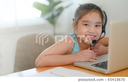 asian girl student wear headphone watch webinar 65418670