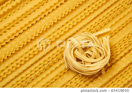 background of dried pasta, tagliatelle and 65419650