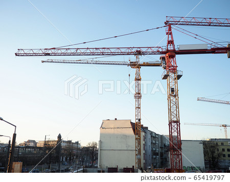 Big hoisting crane standing at blue sky Big hoisting crane standing at blue sky 65419797