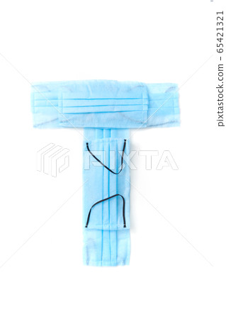 Letter T made from protective medical masks on a white background. 65421321