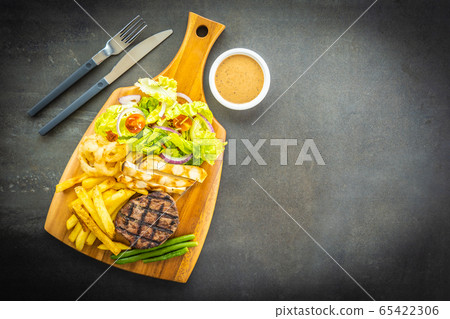 Grilled beef meat steak with french fries sauce and fresh vegetable Grilled beef meat steak with french fries sauce and fresh vegetable 65422306