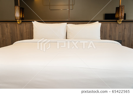 Pillow and blanket on bed with light lamp decoration interior 65422565