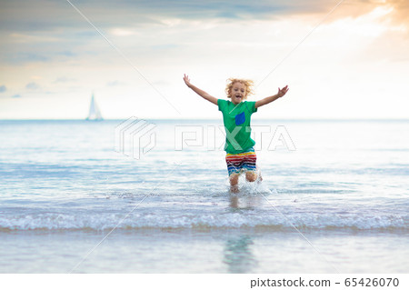 Kids play on tropical beach. Sand and water toy. Kids play on tropical beach. Sand and water toy. 65426070