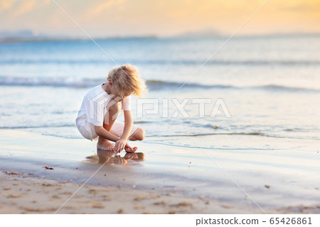 Kids play on tropical beach. Sand and water toy. Kids play on tropical beach. Sand and water toy. 65426861